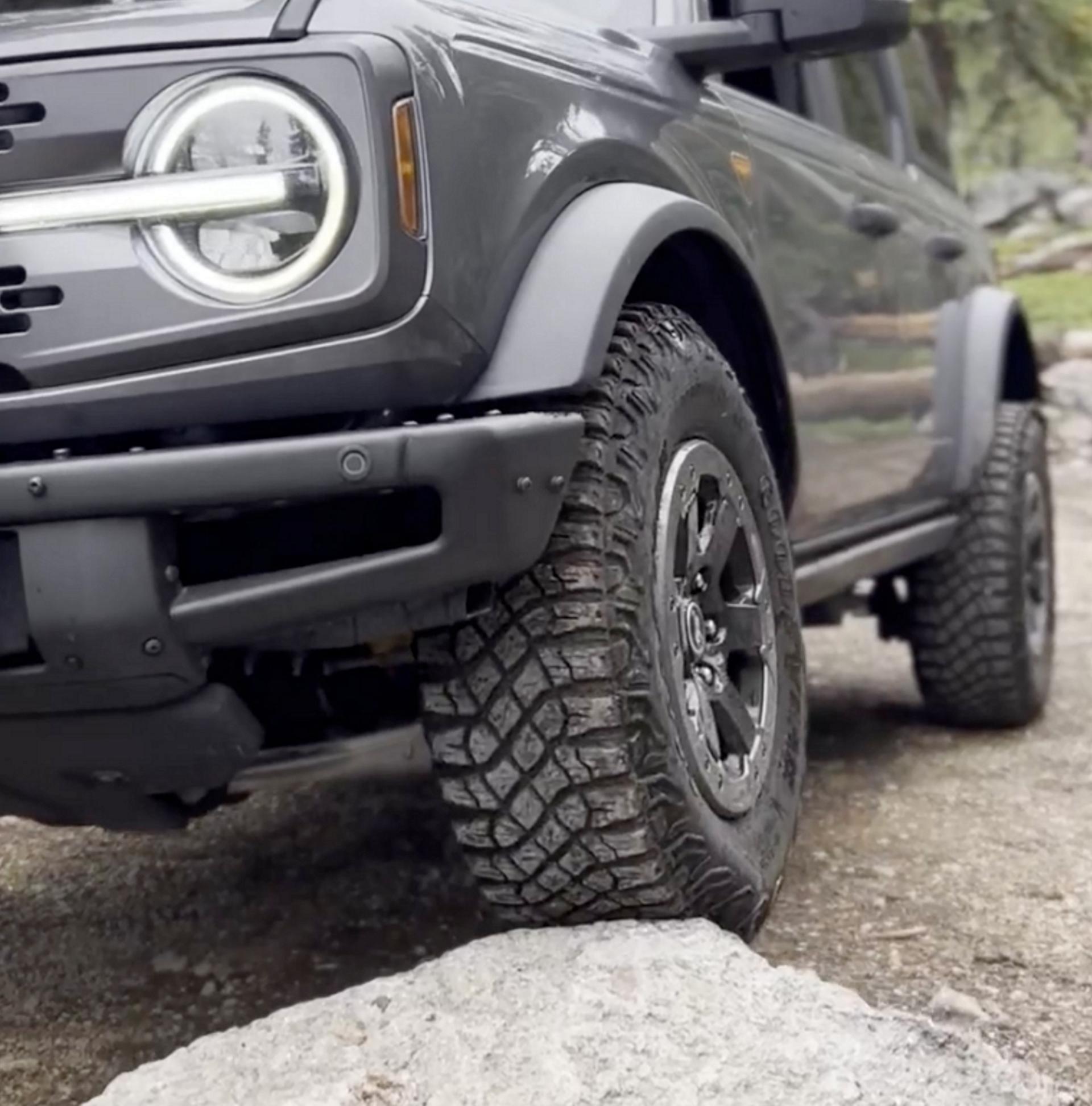 A 2026 Ford Bronco® SUV being driven onto a large boulder