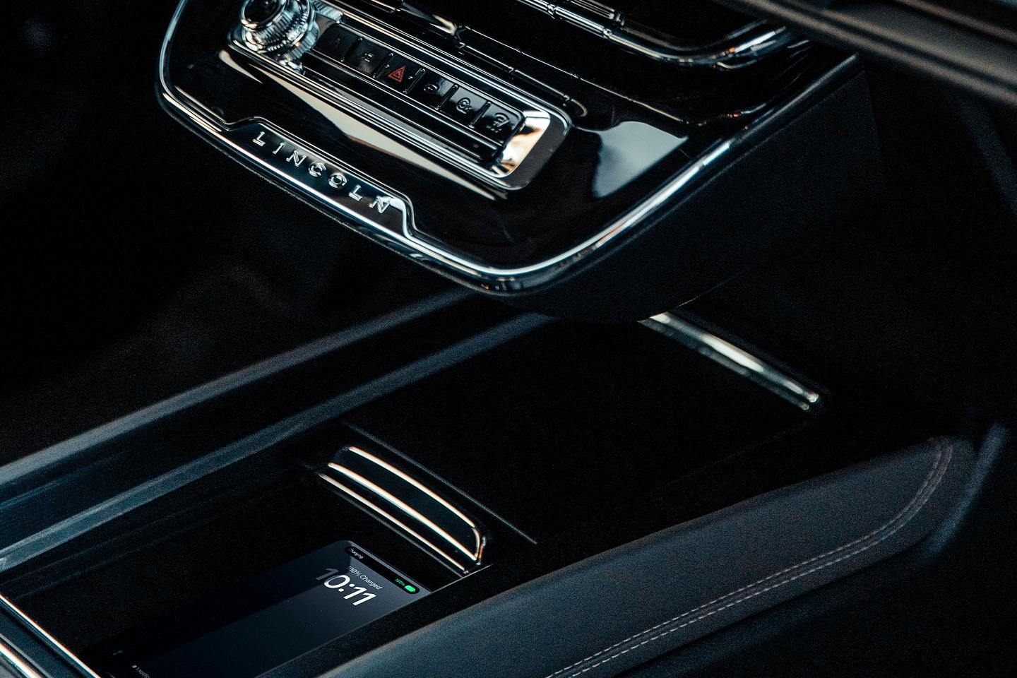 A mobile phone rests on the available wireless charging pad inside a 2025 Lincoln Corsair SUV