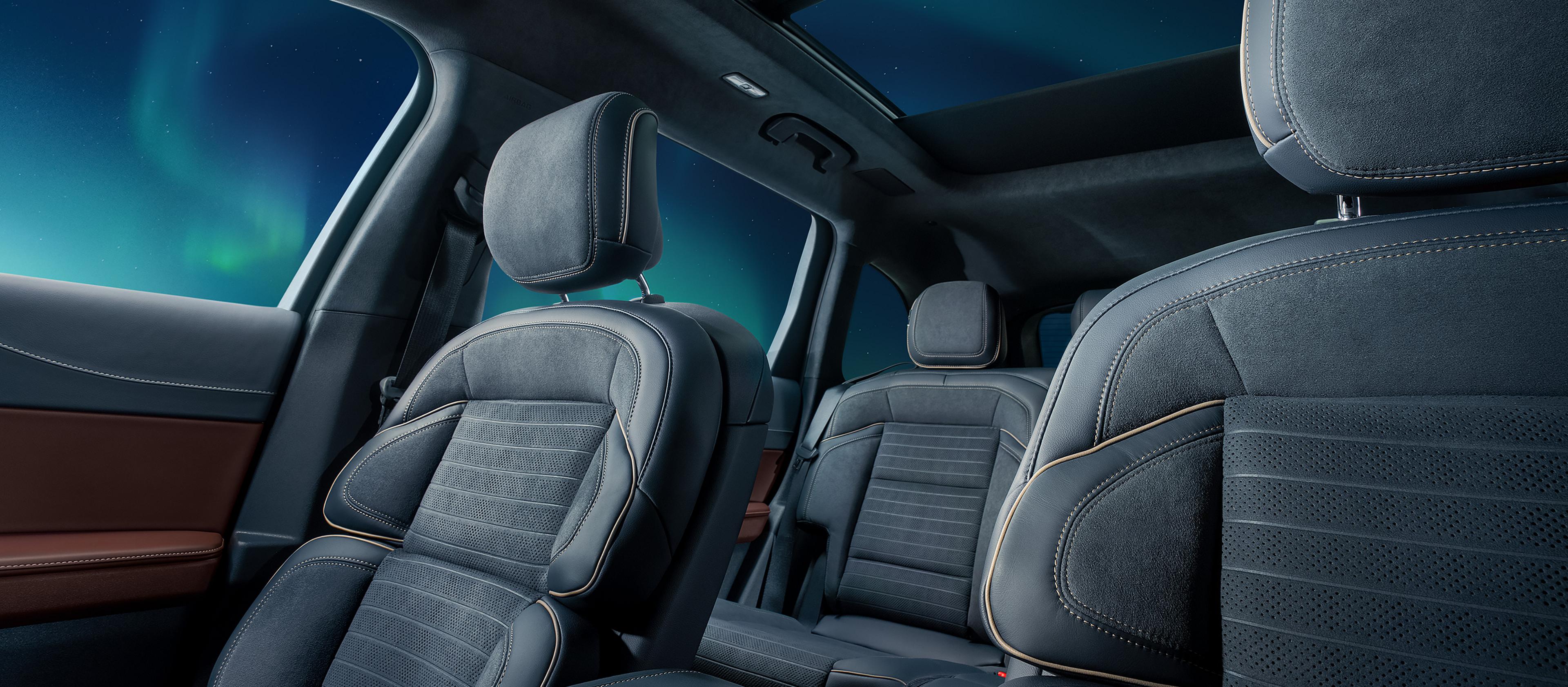 The interior of a 2026 Lincoln Black Label™ Nautilus® SUV in the Aurora interior highlighting the first and second row seating