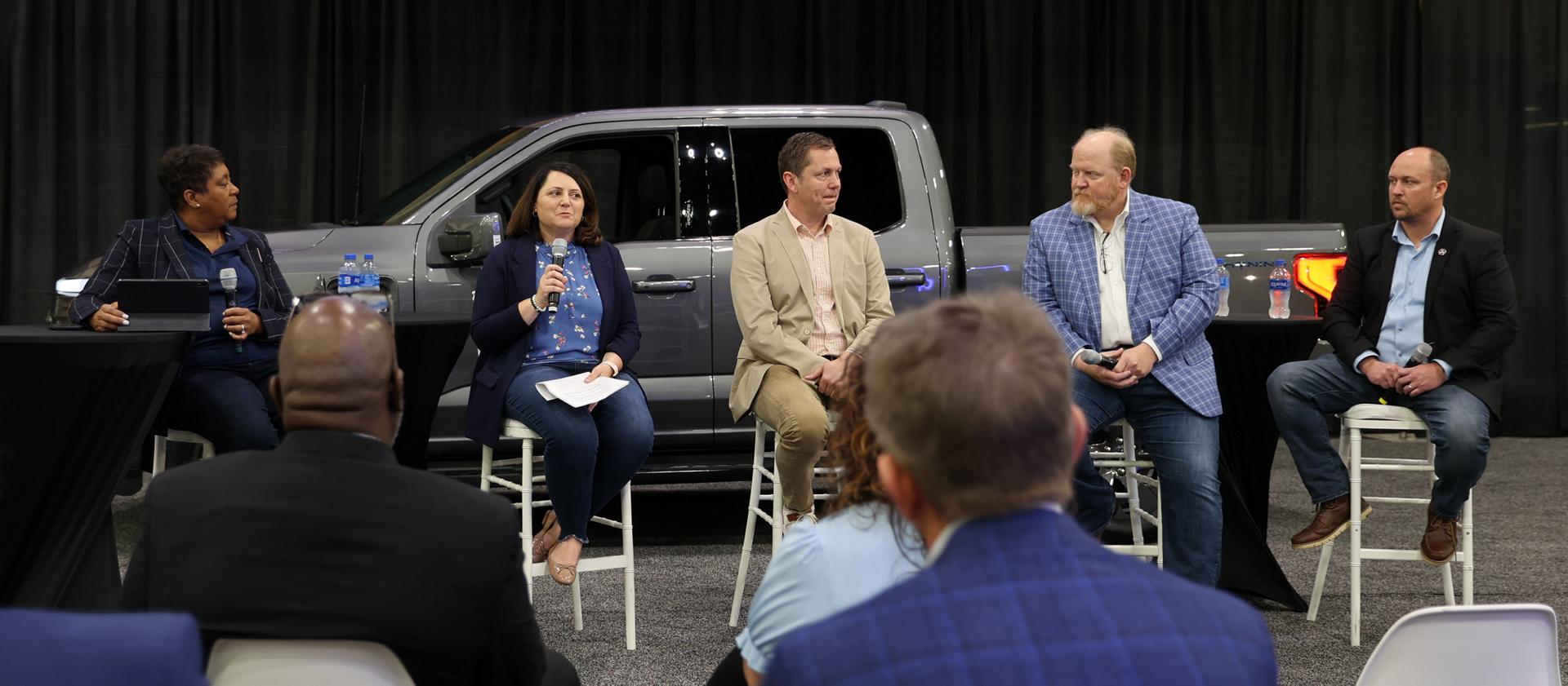 Ford team members on the stage at a conference