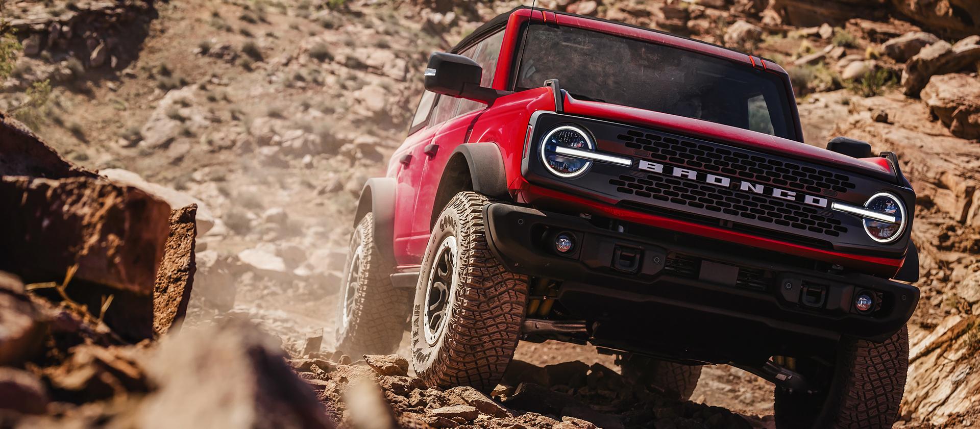 A 2026 Ford Bronco® SUV descending a muddy hill