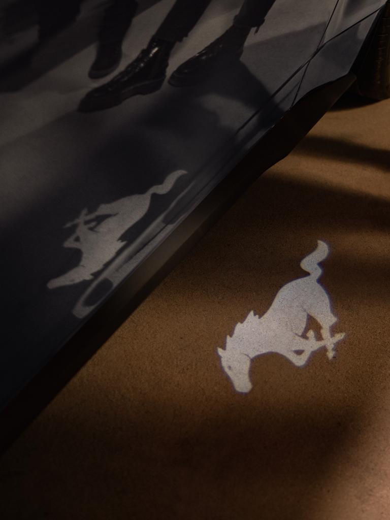 People approaching a 2026 Ford Mustang® GT Premium model with approach detection welcome exterior lighting