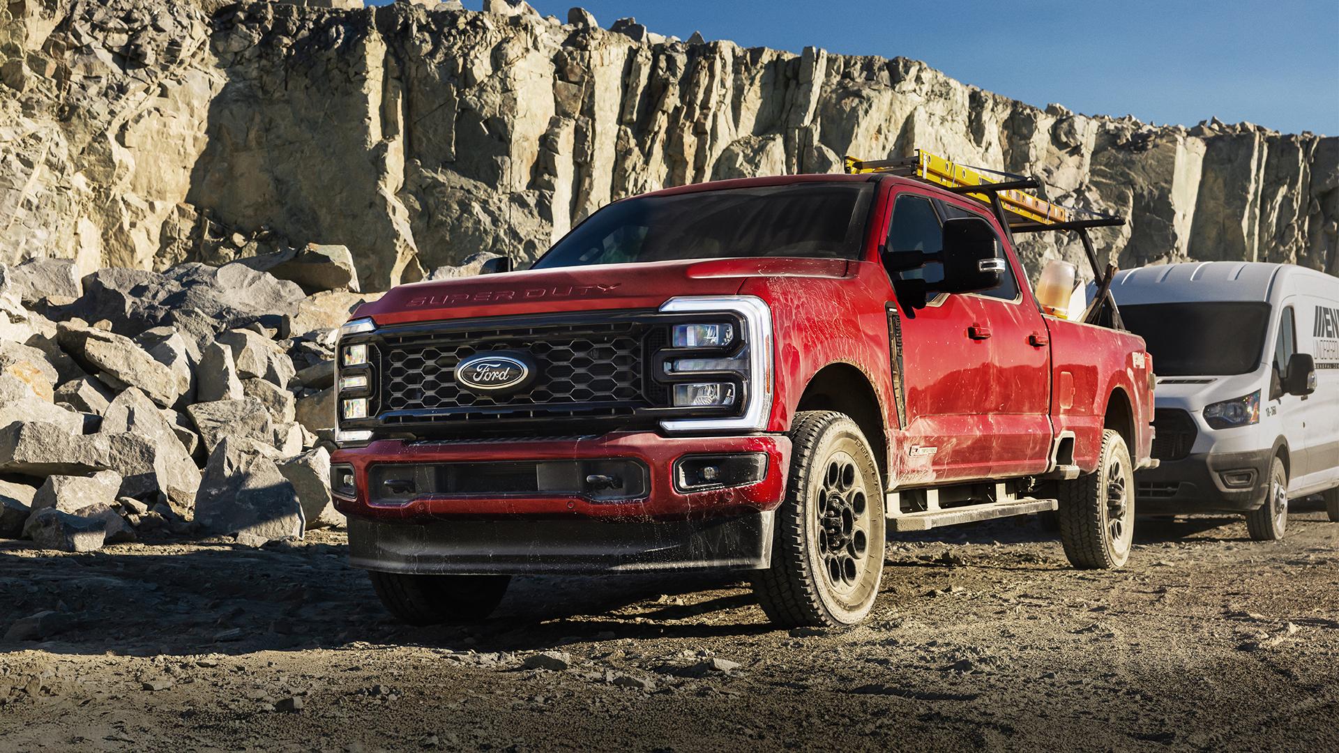 2025 Ford Super Duty® Lariat® sitting on a dirt road in front of a rock wall