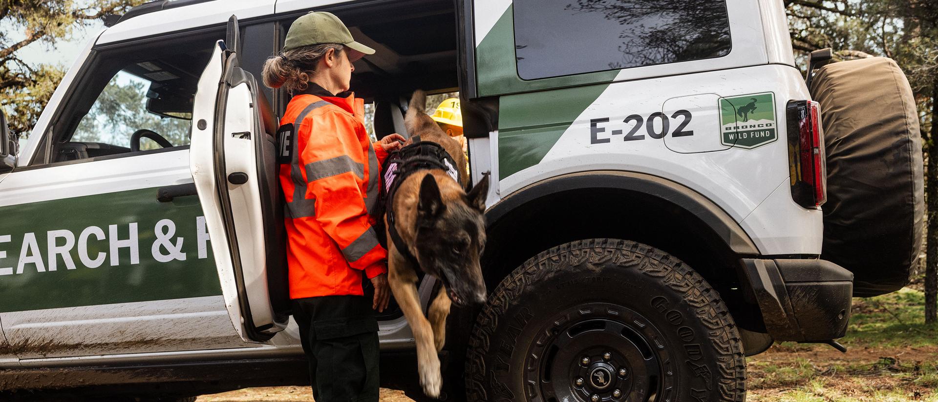 A white with green graphics Ford Bronco Badlands equipped as search and rescue vehicle