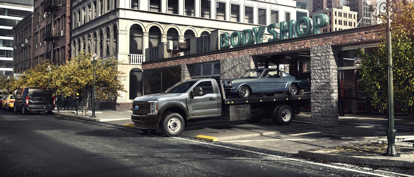 2025 Ford Super Duty® F-600® with tow package hauling a car on the bed