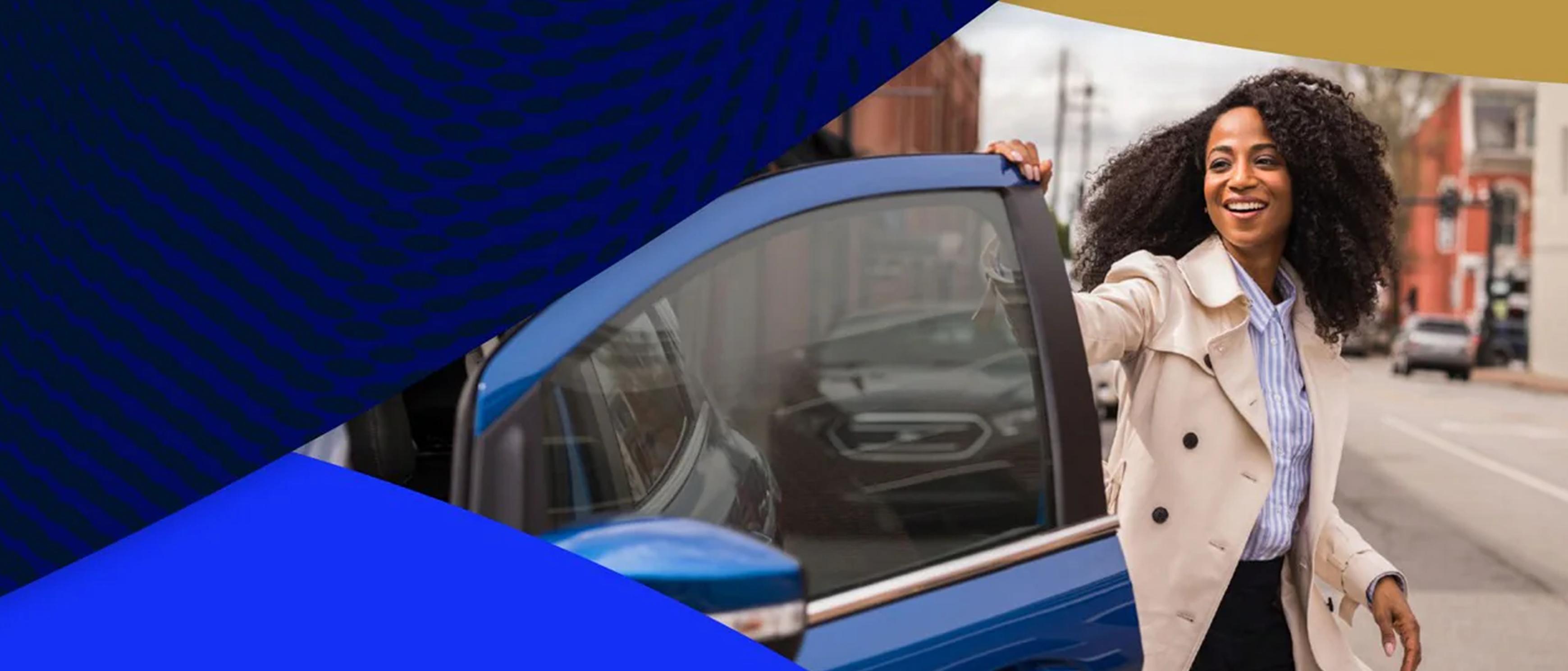 A person steps out of a parked Ford vehicle and smiles while closing the door