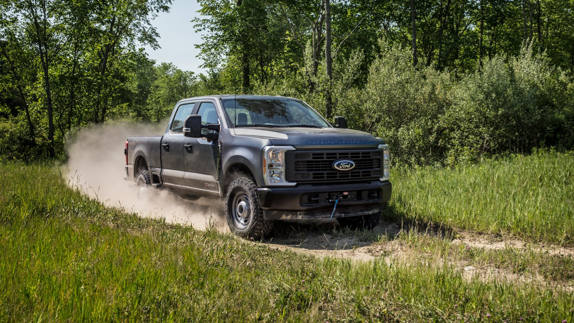 2026 Ford Super Duty® F-250® XL in Carbonized Gray pulling a trailer on a paved road