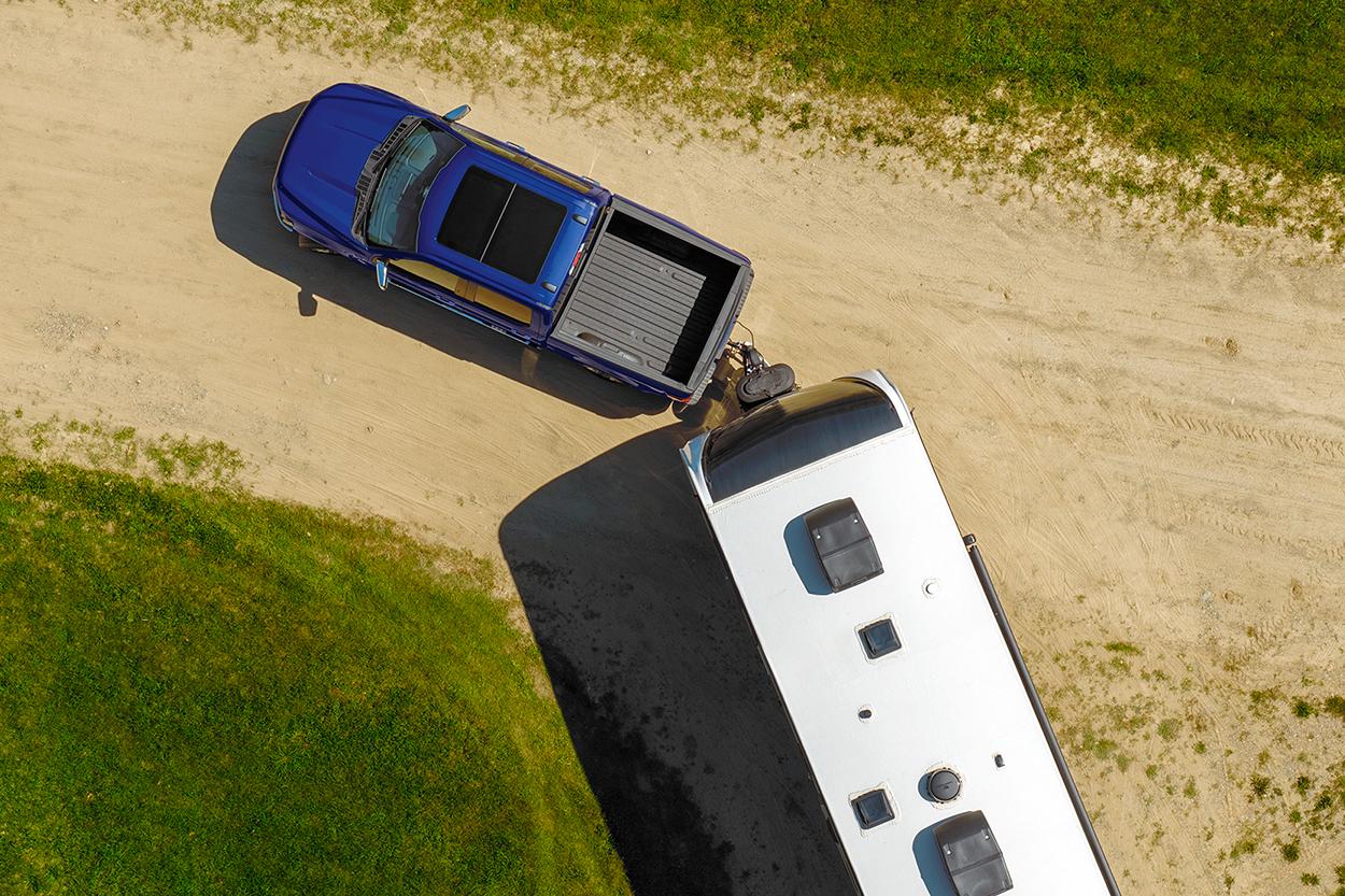 2026 Ford F-150® pulling a trailer on a dirt road