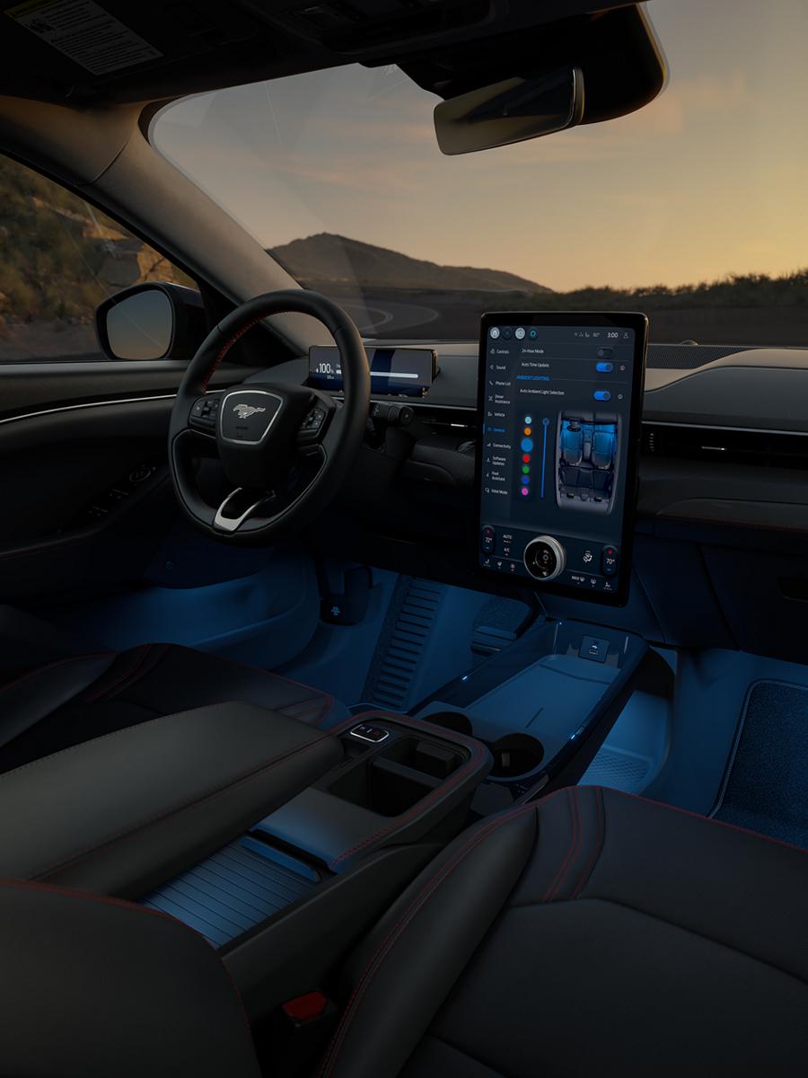 Interior of a 2026 Mustang Mach-E® SUV with a view of the driver's seat, dashboard, and scenic mountain landscape