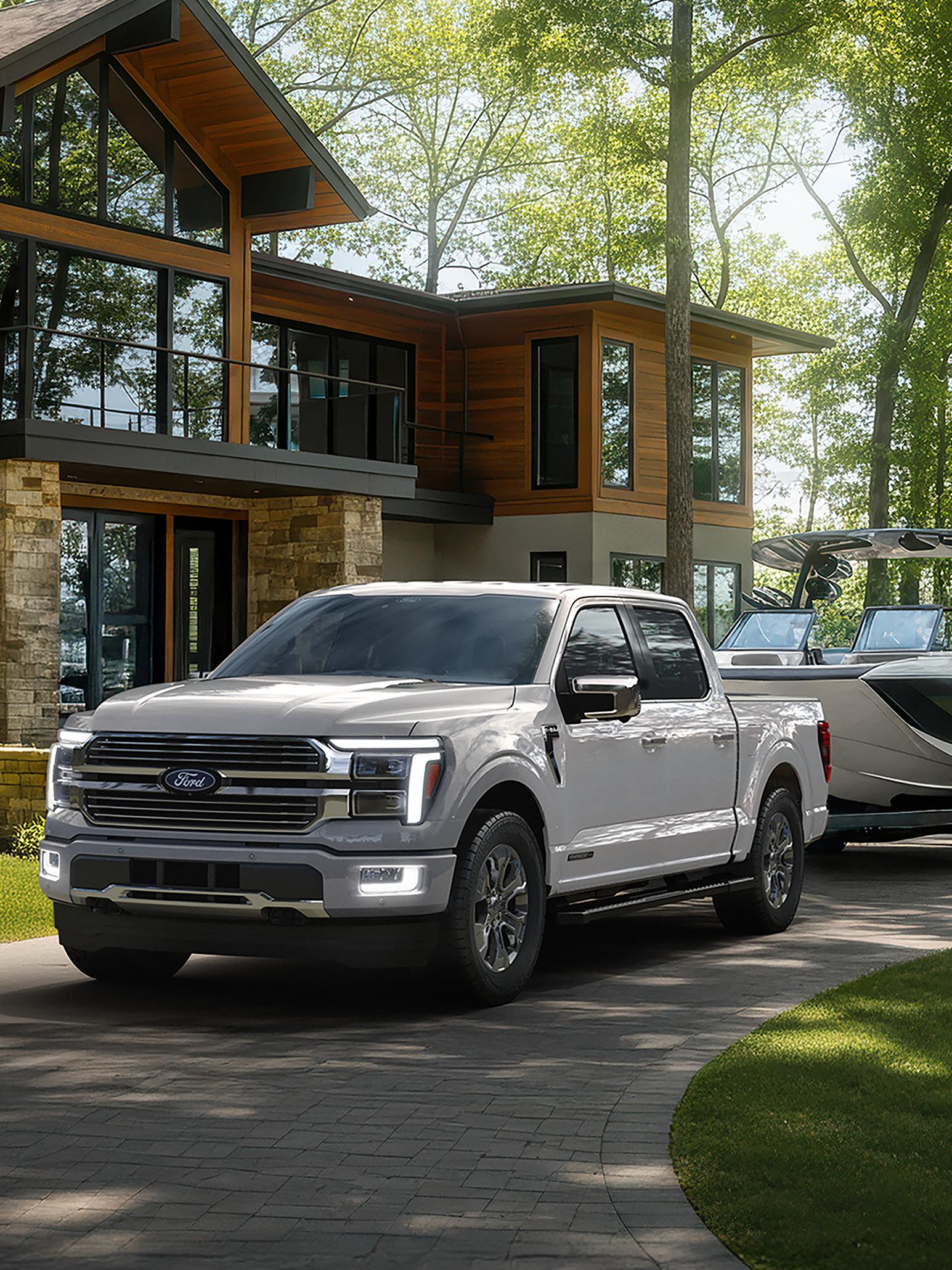 2026 Ford F-150® Platinum® model with the Satin Package pulling a small trailer on a country road