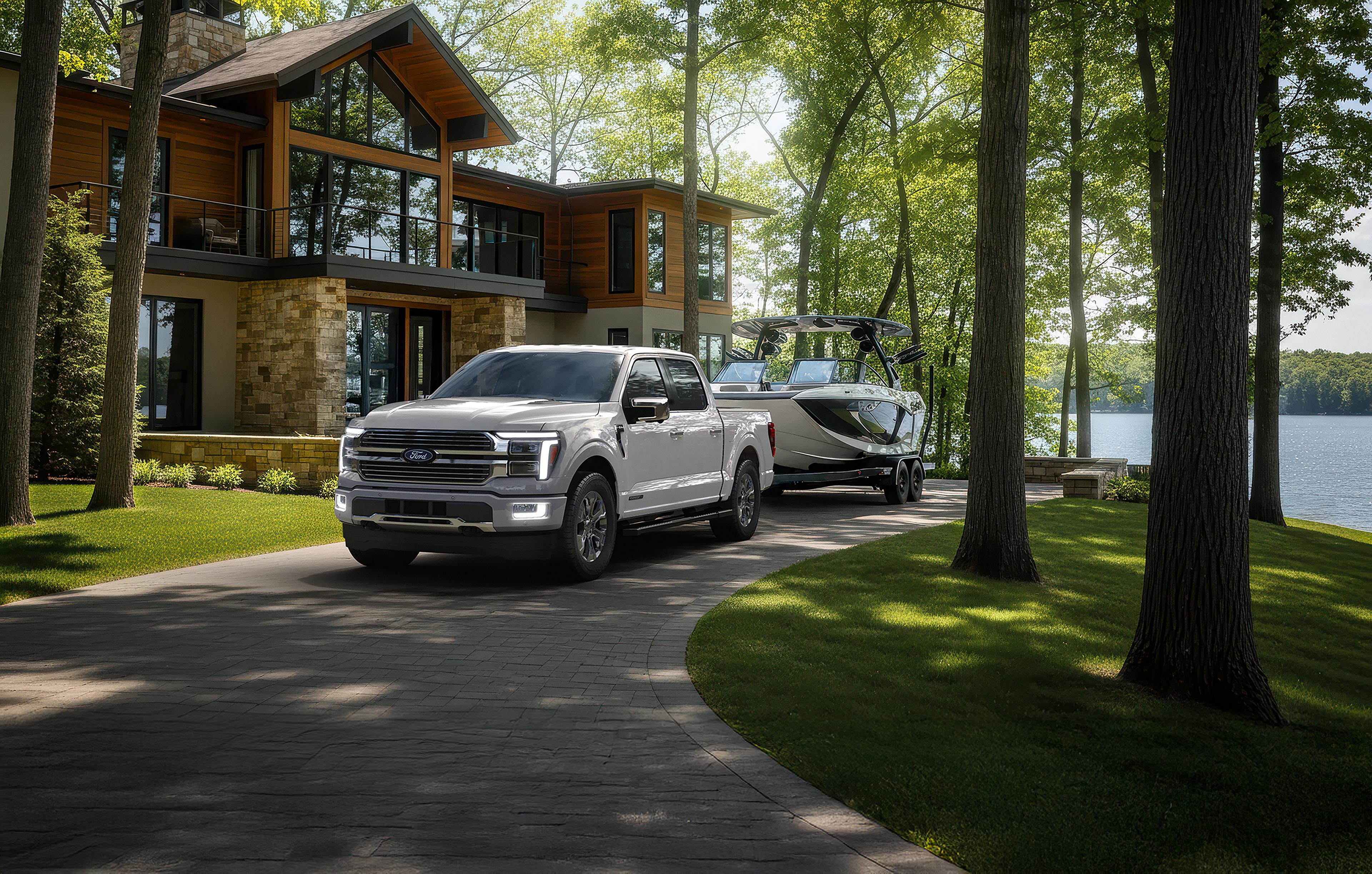 2026 Ford F-150® Platinum® model hitched to a boat trailer parked near a house