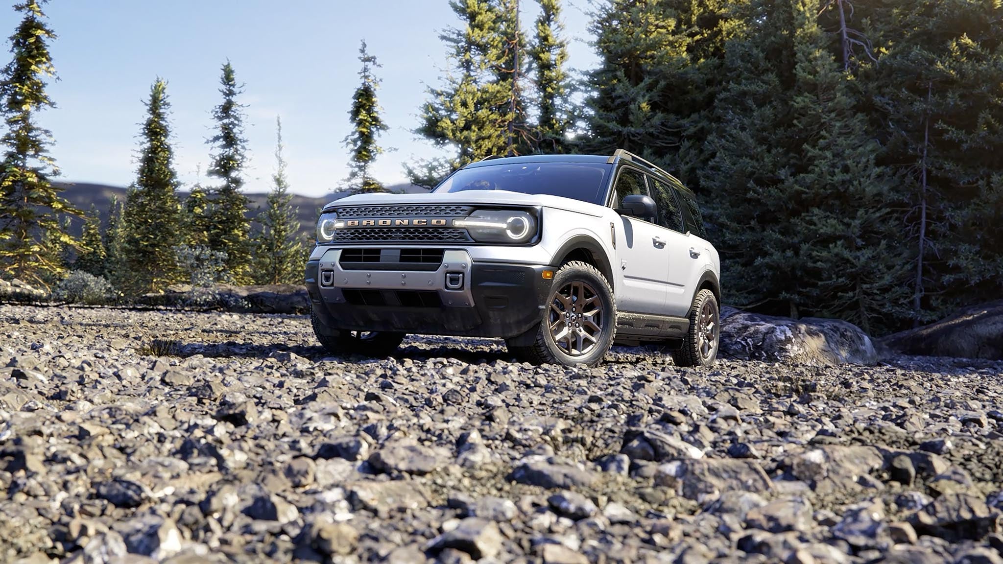 2026 Ford Bronco Sport parked in the woods - compare Bronco vs Bronco Sport at Tom Masano Ford