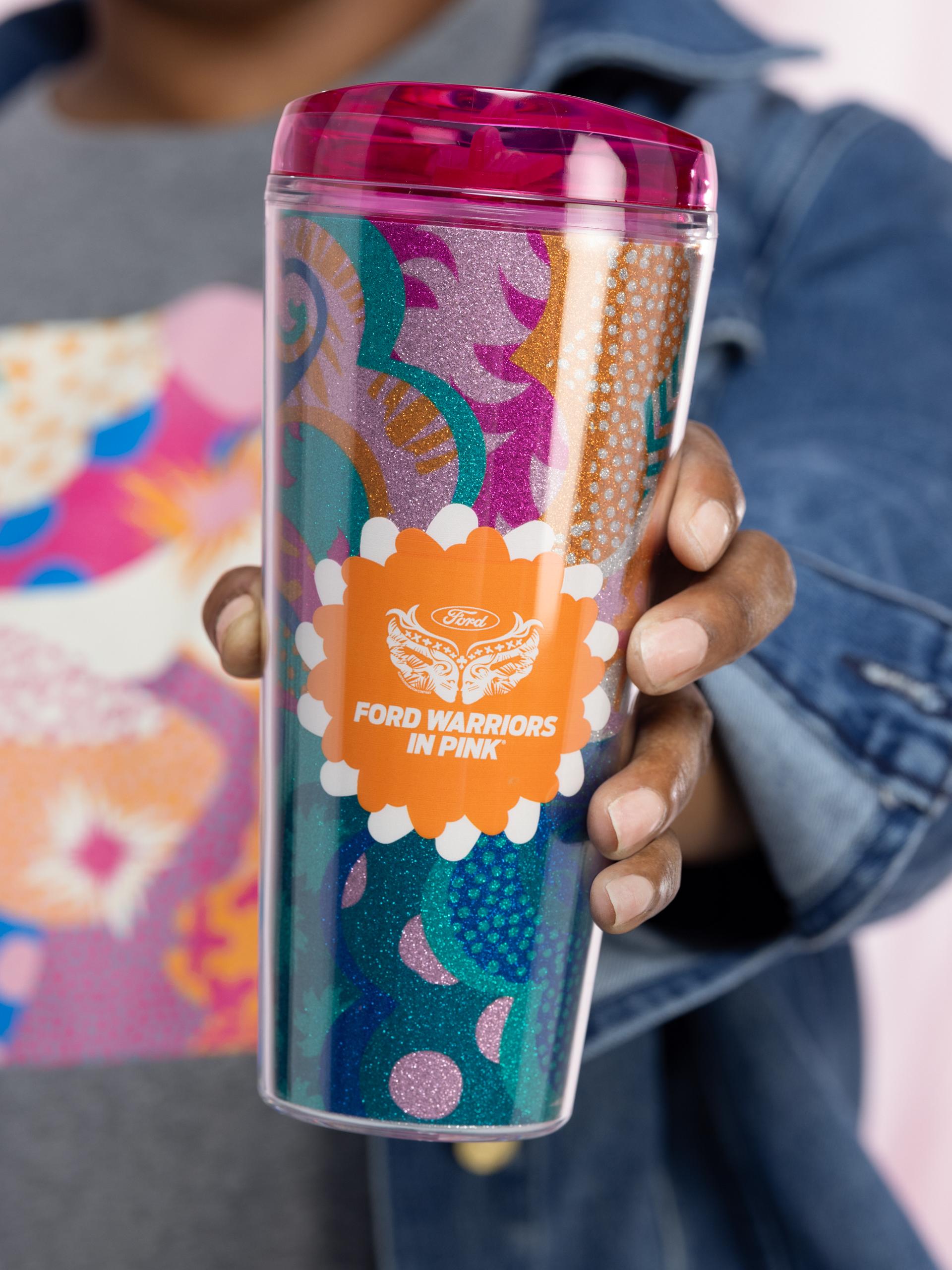 A close-up of a Ford Warriors in Pink tumbler being held up to camera