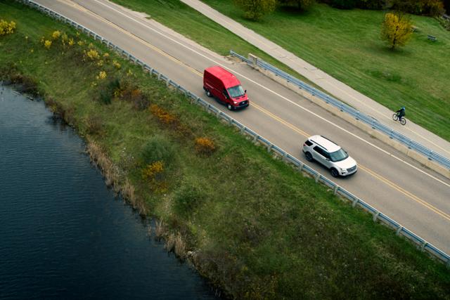Birds-eye view of a 2025 Ford Transit® van being driven on a highway