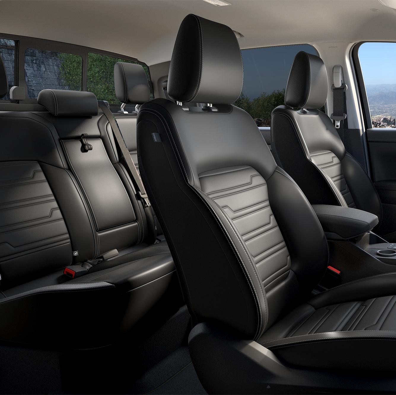 Three-quarter interior view of black leather front and rear of a Ford Ranger. 