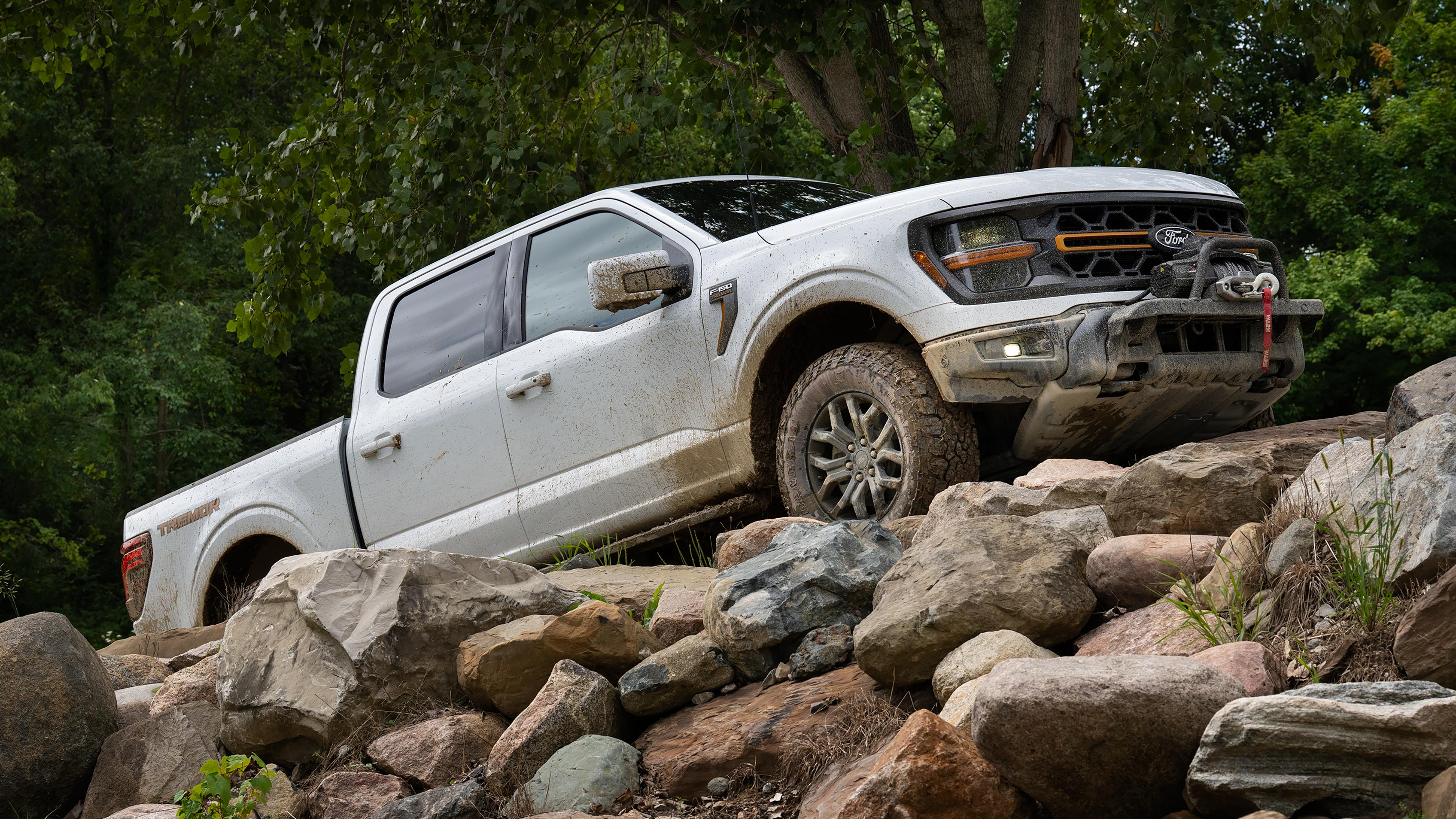 2026 Ford F-150® Tremor® pickup in Oxford White being driven up a rocky slope