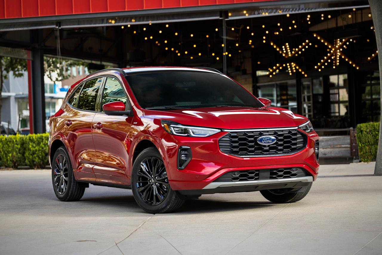 Rapid Red 2026 Ford Escape® SUV parked in front of a building with decorative string lights