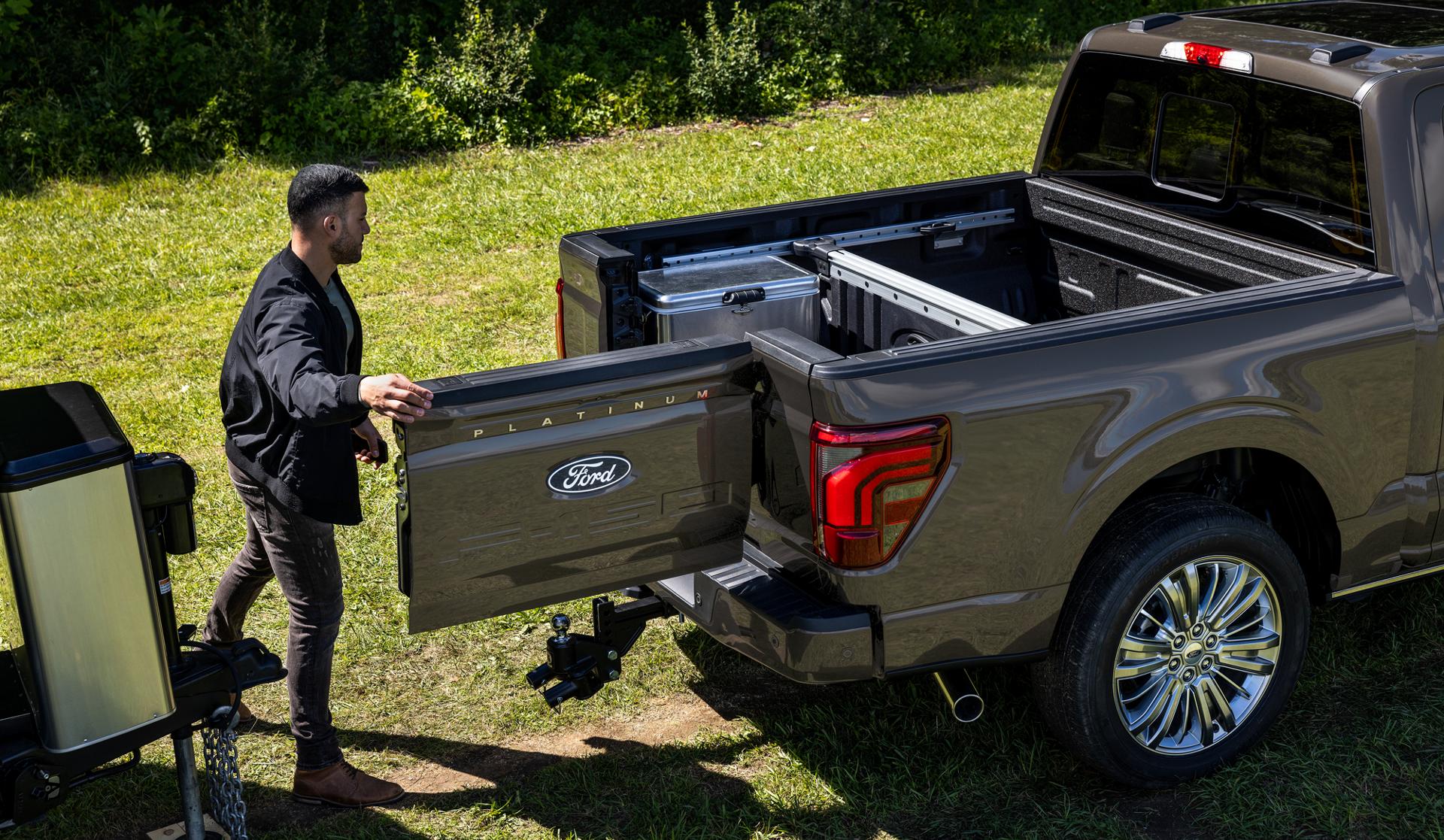 Man using the Pro Access Tailgate feature on a 2026 Ford F-150® Platinum® model