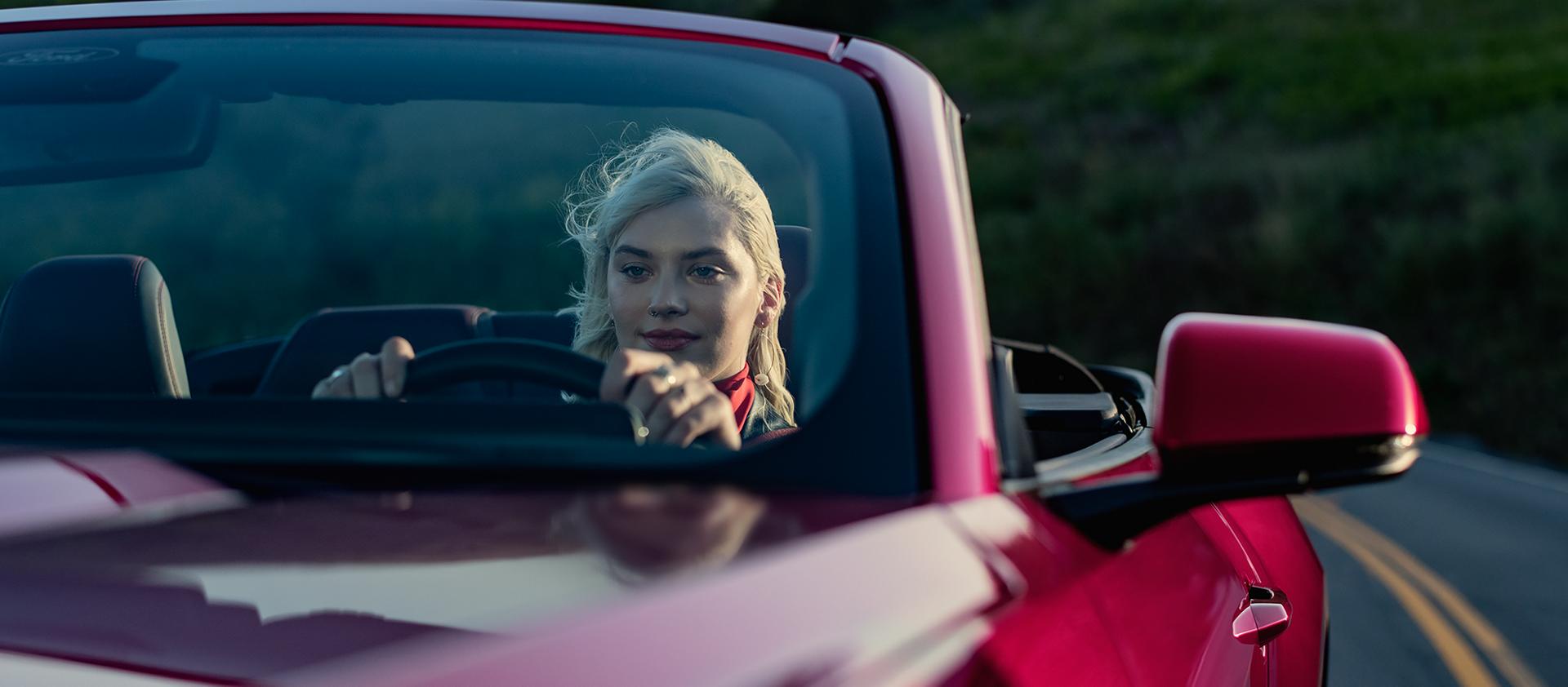 Person driving a 2026 Ford Mustang® GT convertible on a highway