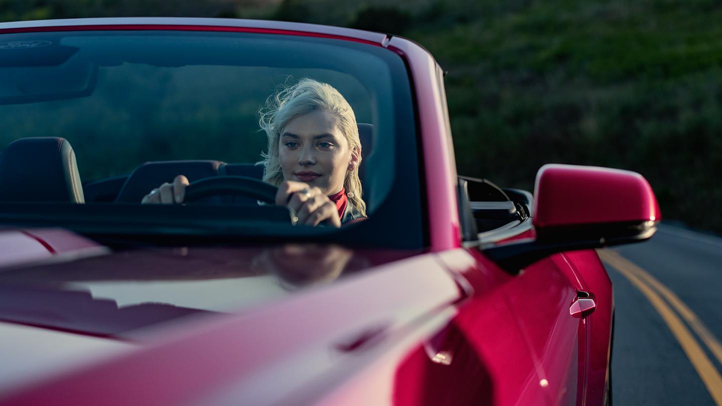 Person driving a 2026 Ford Mustang® GT convertible on a highway