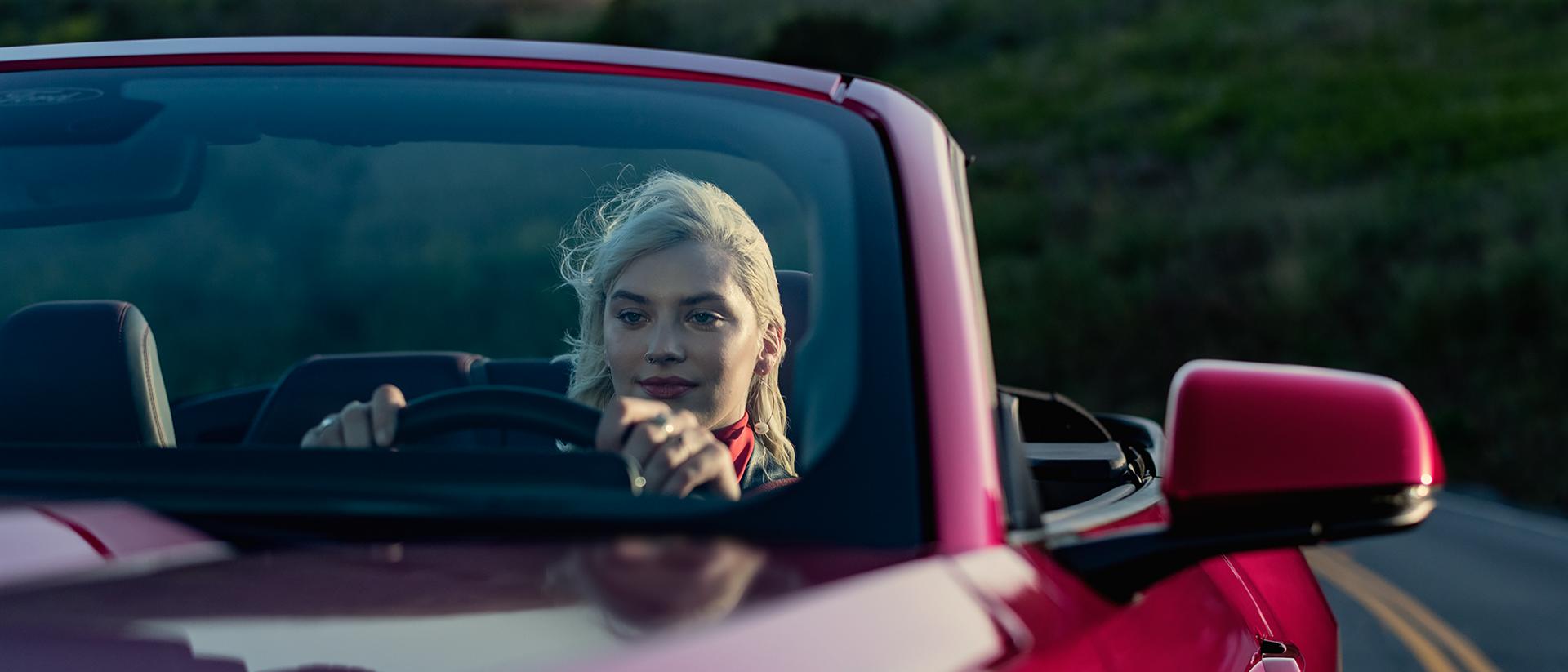 Person driving a 2026 Ford Mustang® GT convertible on a highway