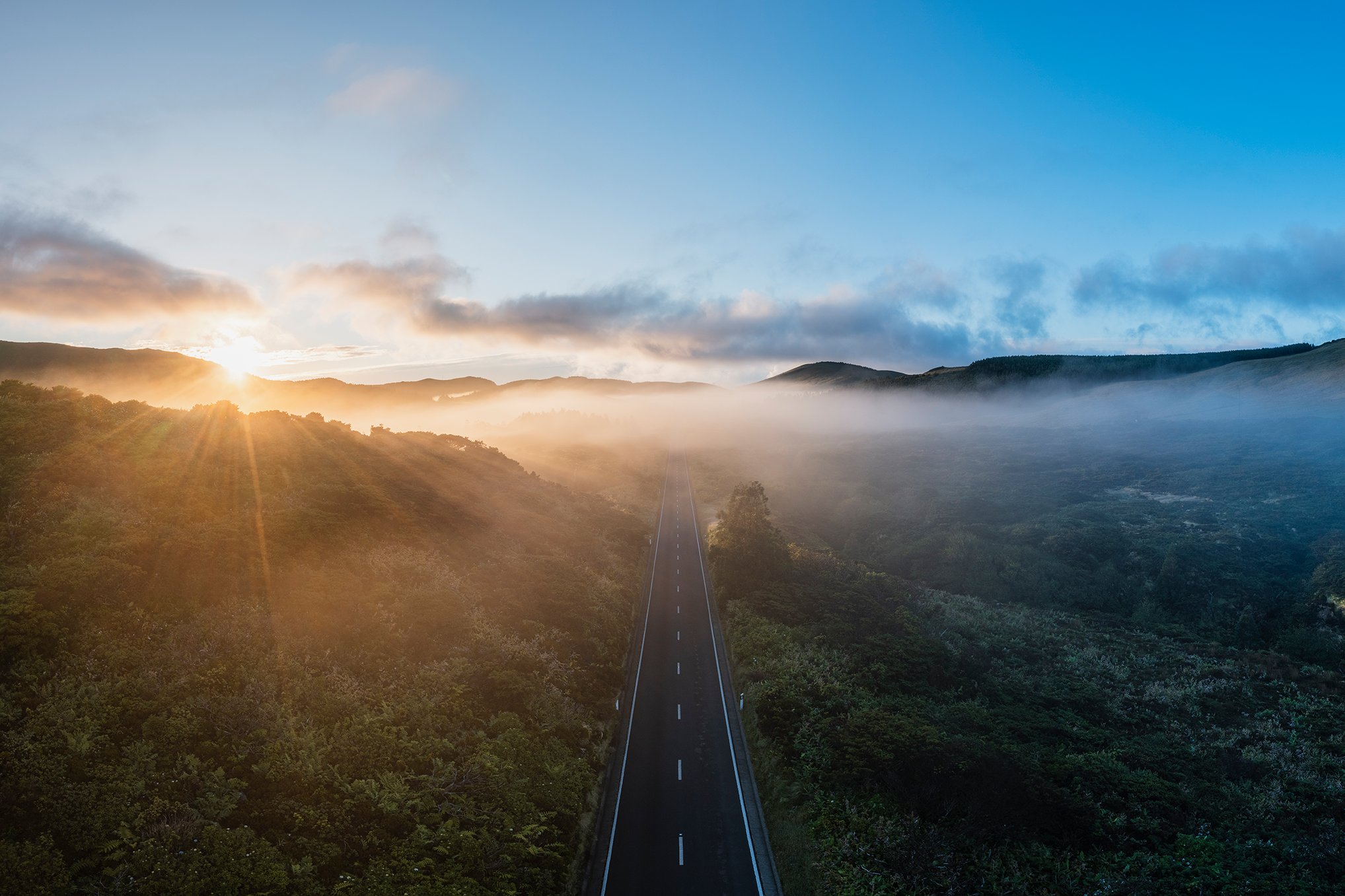 A scenic road leading into a sunset.