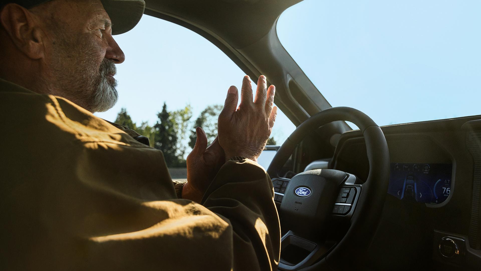 Man using the BlueCruise hands-free highway driving feature on a 2026 Ford F-150® pickup