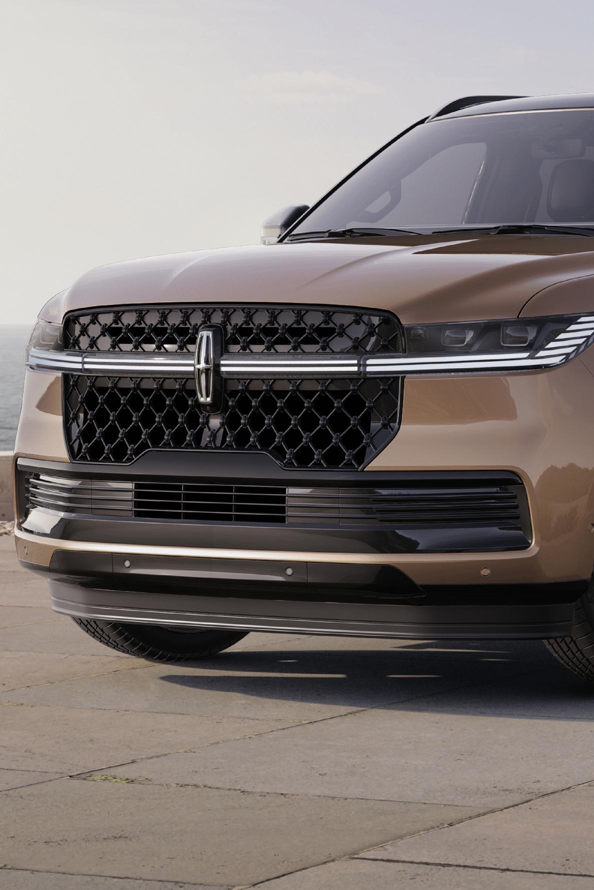 A 2025 Lincoln Navigator® SUV is parked at a scenic ocean-side overlook.