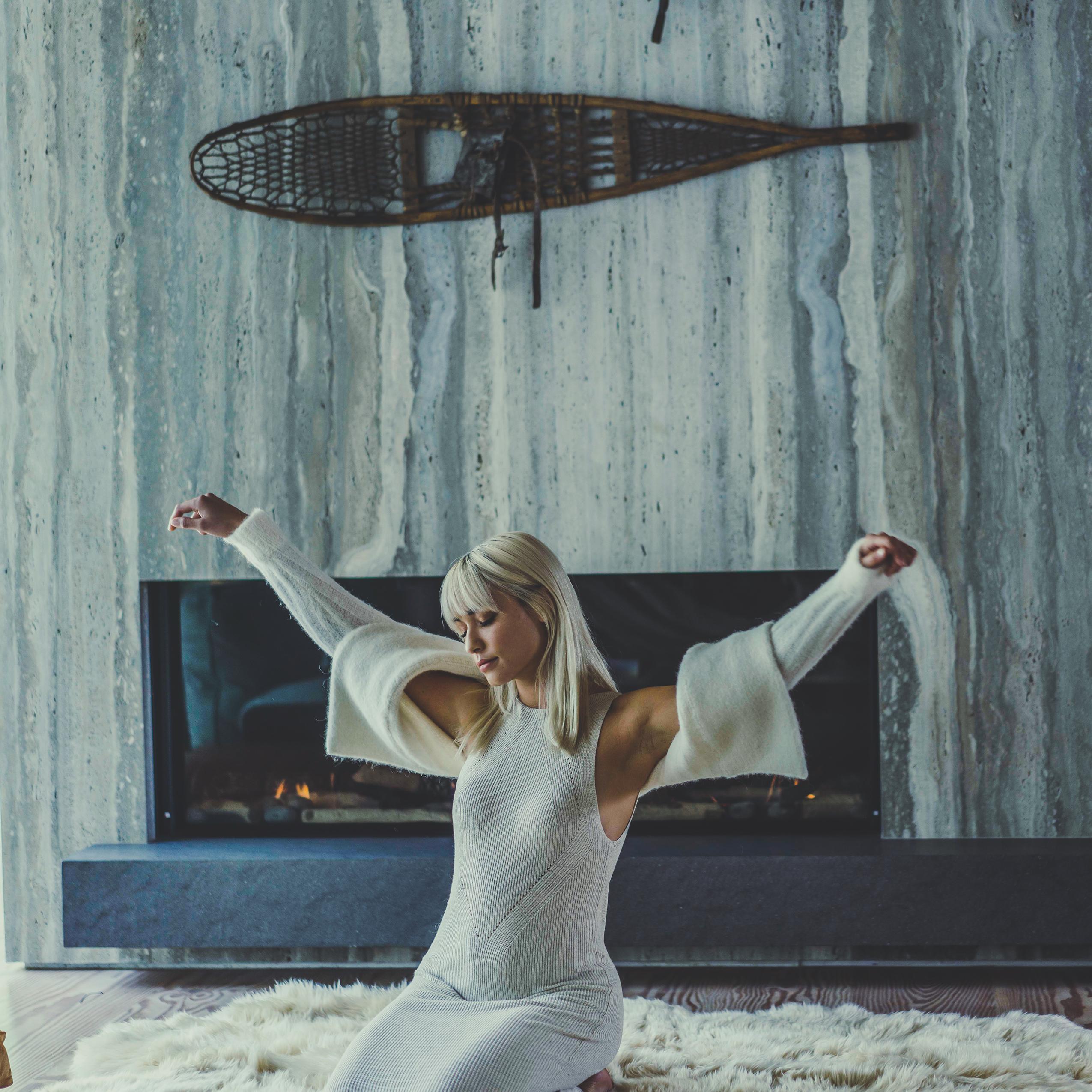 A woman relaxes in a home reminiscent of the Chalet theme