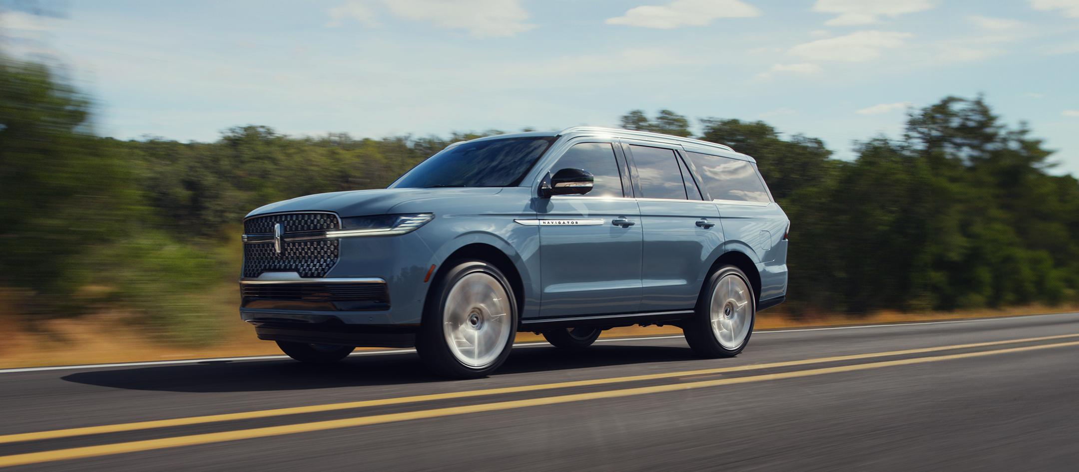 The 2025 Lincoln Navigator driving down the road.