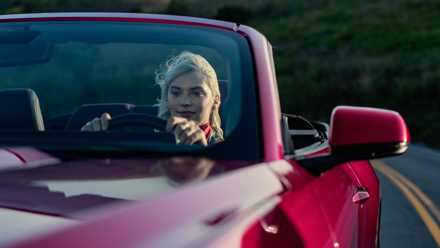 Person driving a 2025 Ford Mustang® GT Convertible on a highway