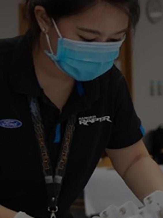 Young woman wearing mask making personal protection equipment
