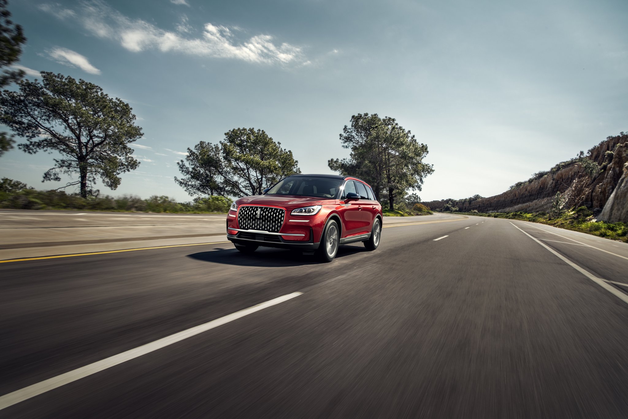 A 2025 Lincoln Corsair® SUV is being driven on a countryside road