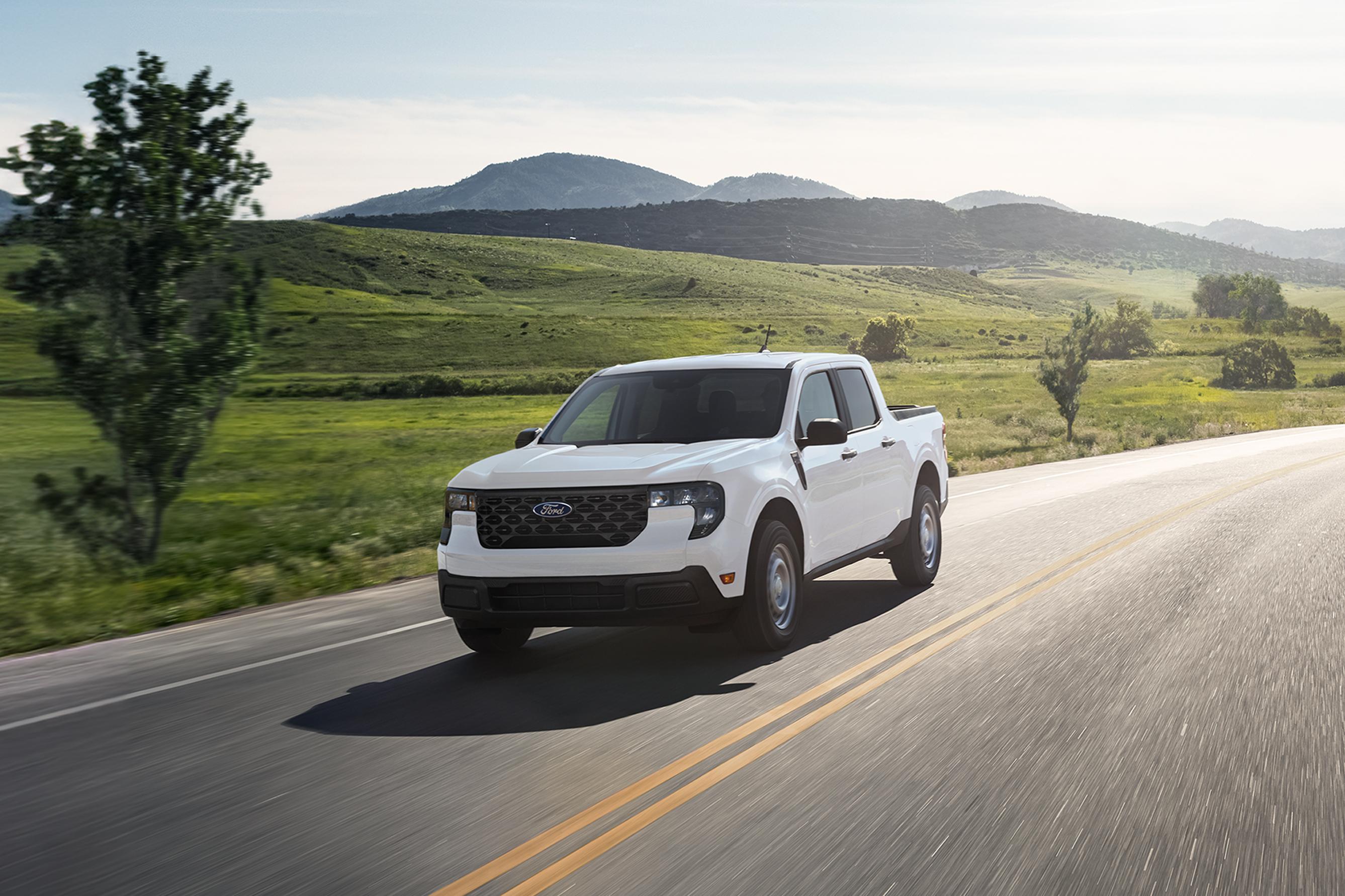 2026 Ford Maverick® pickup in Oxford White being driven on a country highway