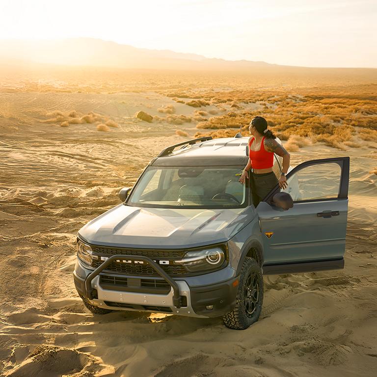A 2026 Ford Bronco Sport® parked in the desert with a person standing outside the vehicle