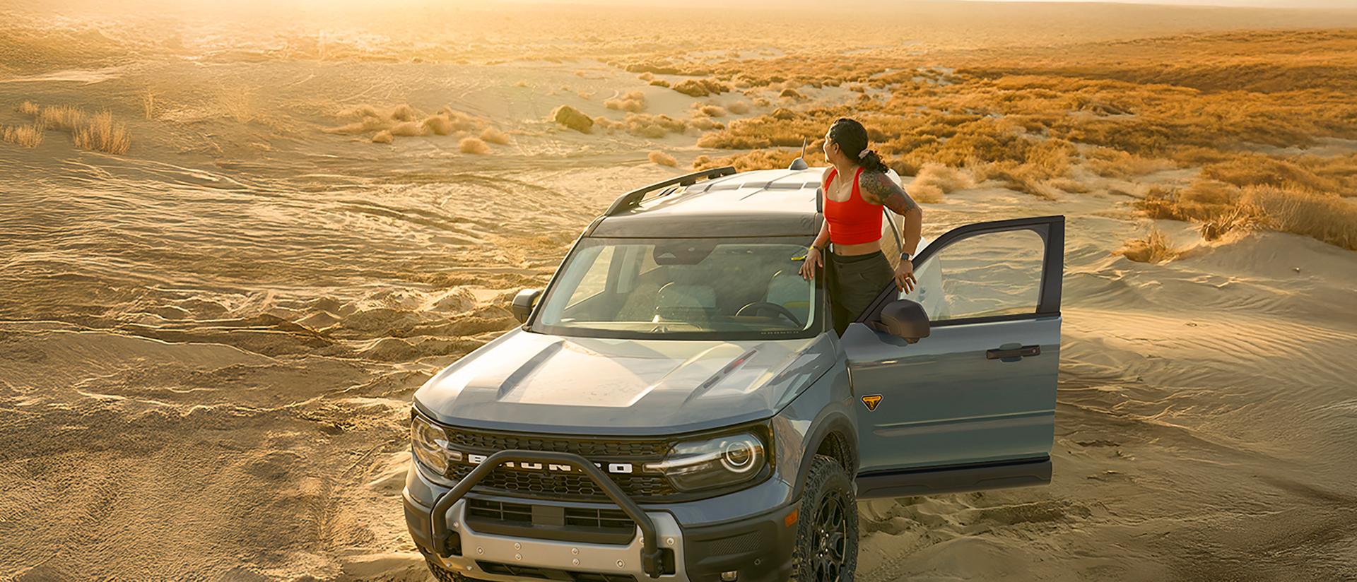 A 2026 Ford Bronco Sport® parked in the desert with a person standing outside the vehicle