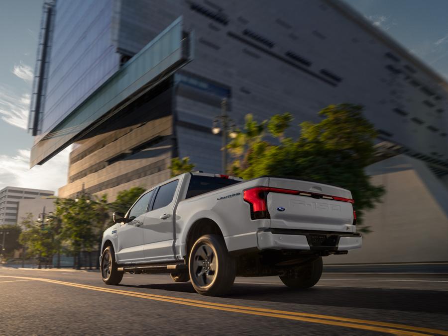 Lower rear view of an F-150 Lightning® being driven down a city street