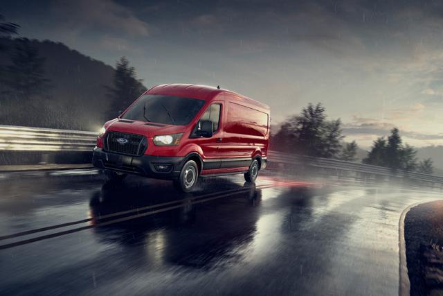 A 2025 Ford Transit® van being driven on a rain-soaked road