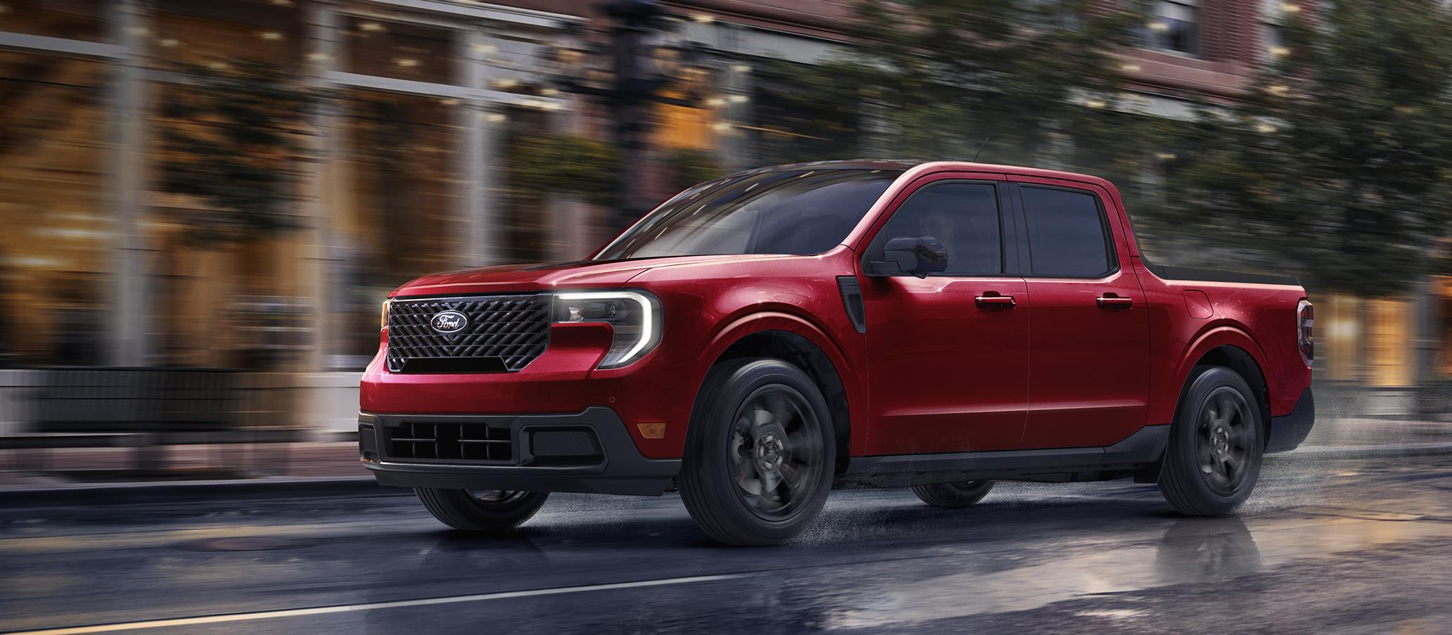 2026 Ford Maverick® pickup with Black Appearance Package being driven on a city street in the evening