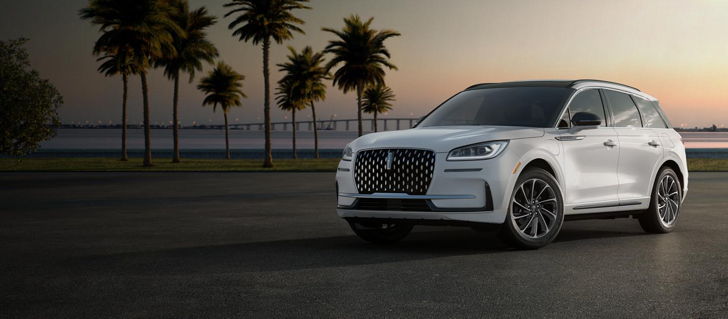 A Lincoln Corsair® Grand Touring set against a sunset and palm trees