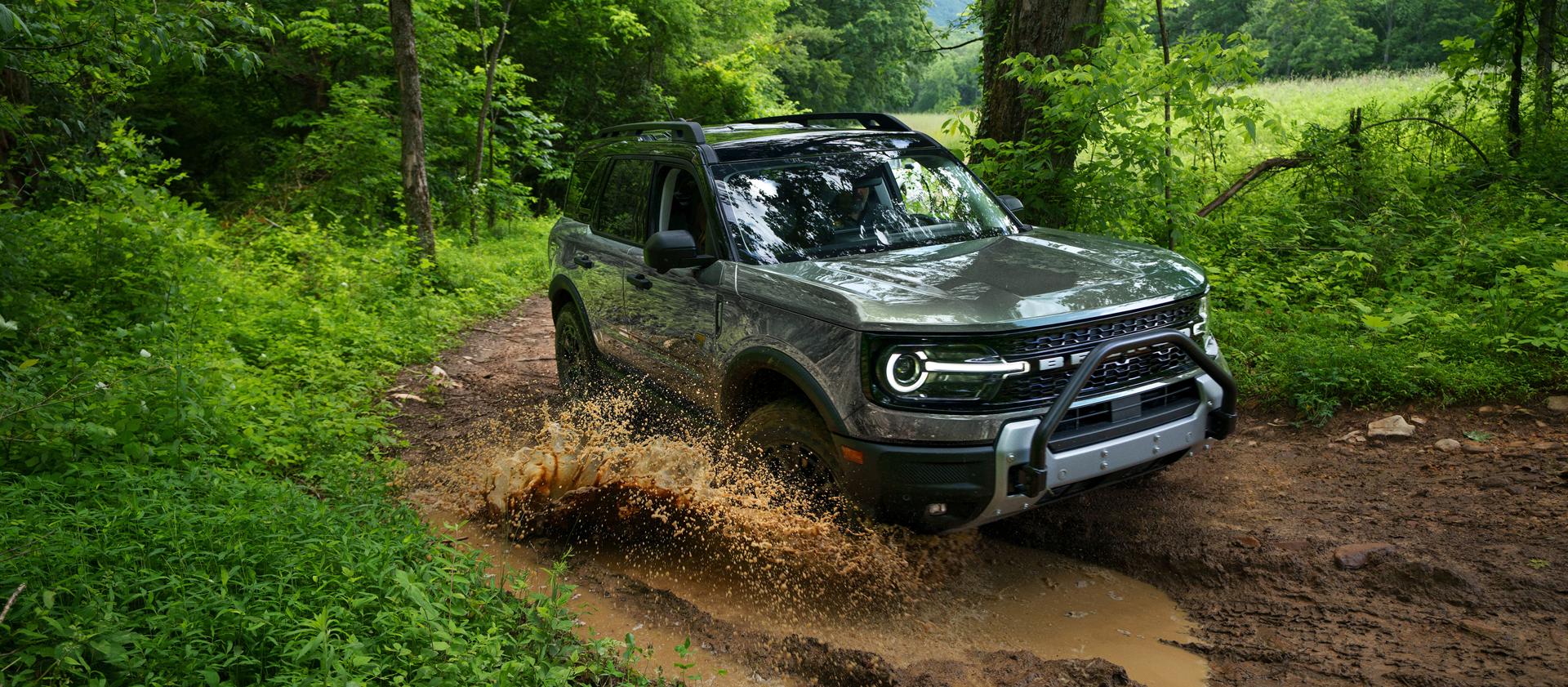 2026 Ford Bronco Sport® being driven on a dirt trail in the woods