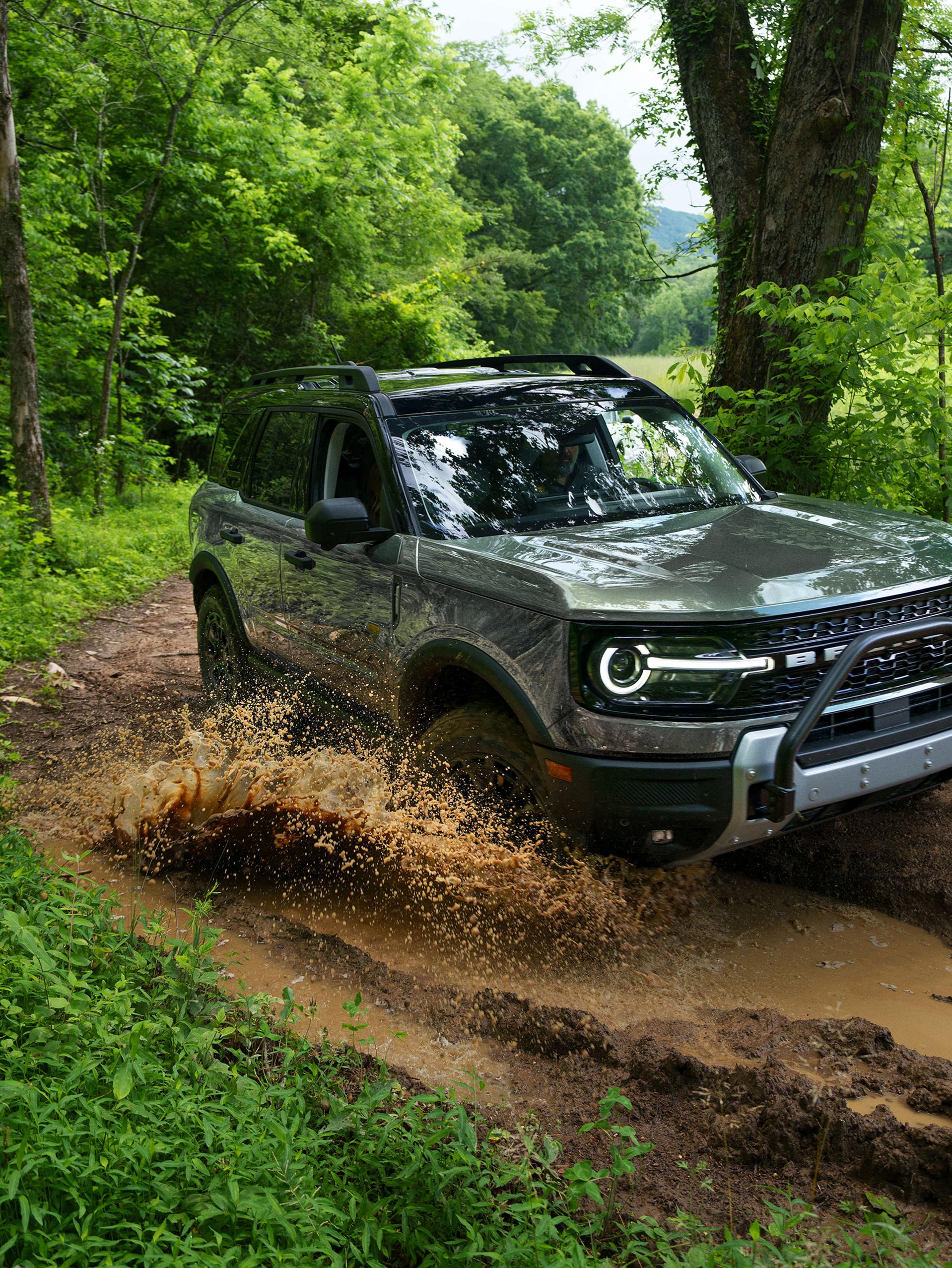 2026 Ford Bronco Sport® being driven on a dirt trail in the woods