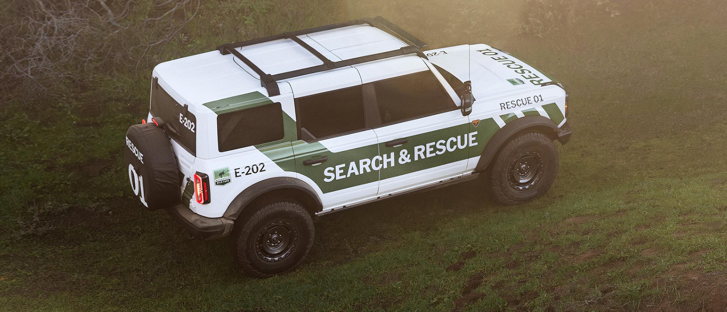 A white with green graphics Ford Bronco Badlands equipped as search and rescue vehicle.