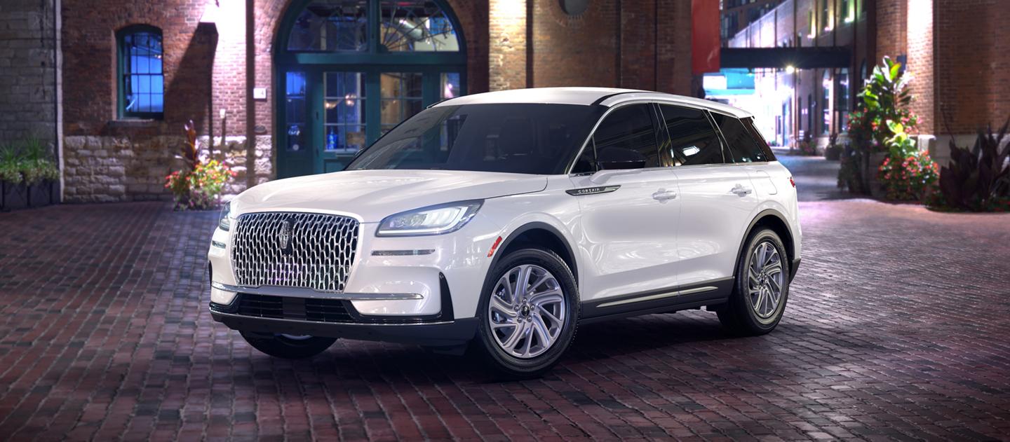 A 2025 Lincoln Corsair® premiere model is parked in a city at night