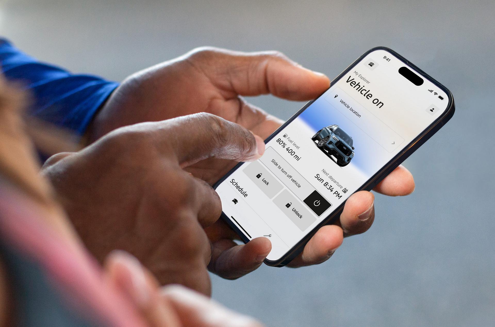 Person using the Ford app on a smartphone to view vehicle status