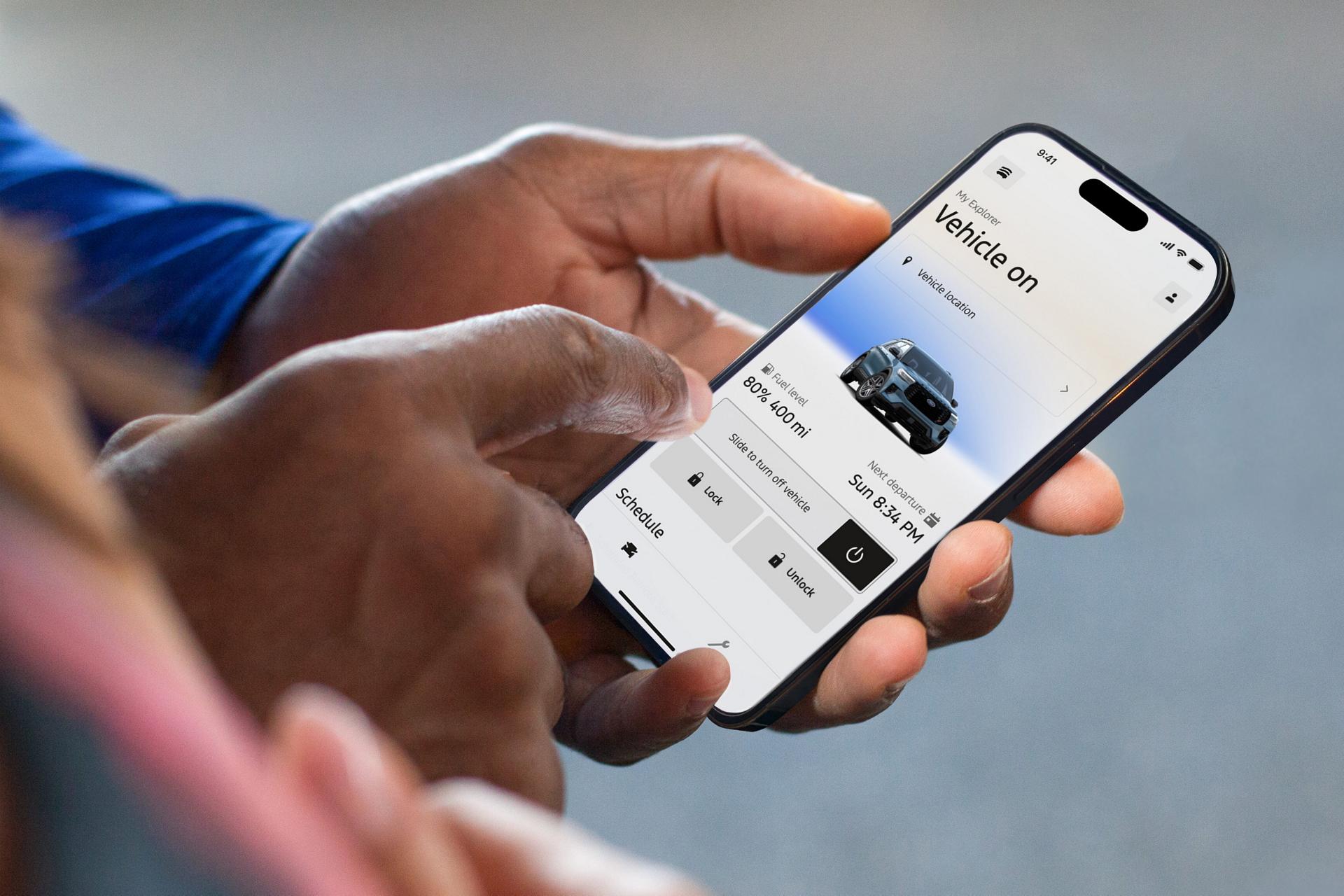 Person using the Ford app on a smartphone to view vehicle status