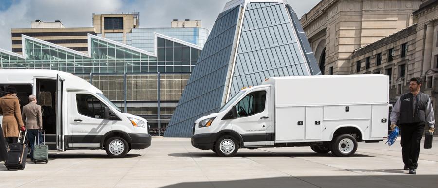 People near a 2025 Ford Transit® model with shuttle bus body and a 2025 Ford Transit® model with aftermarket utility body