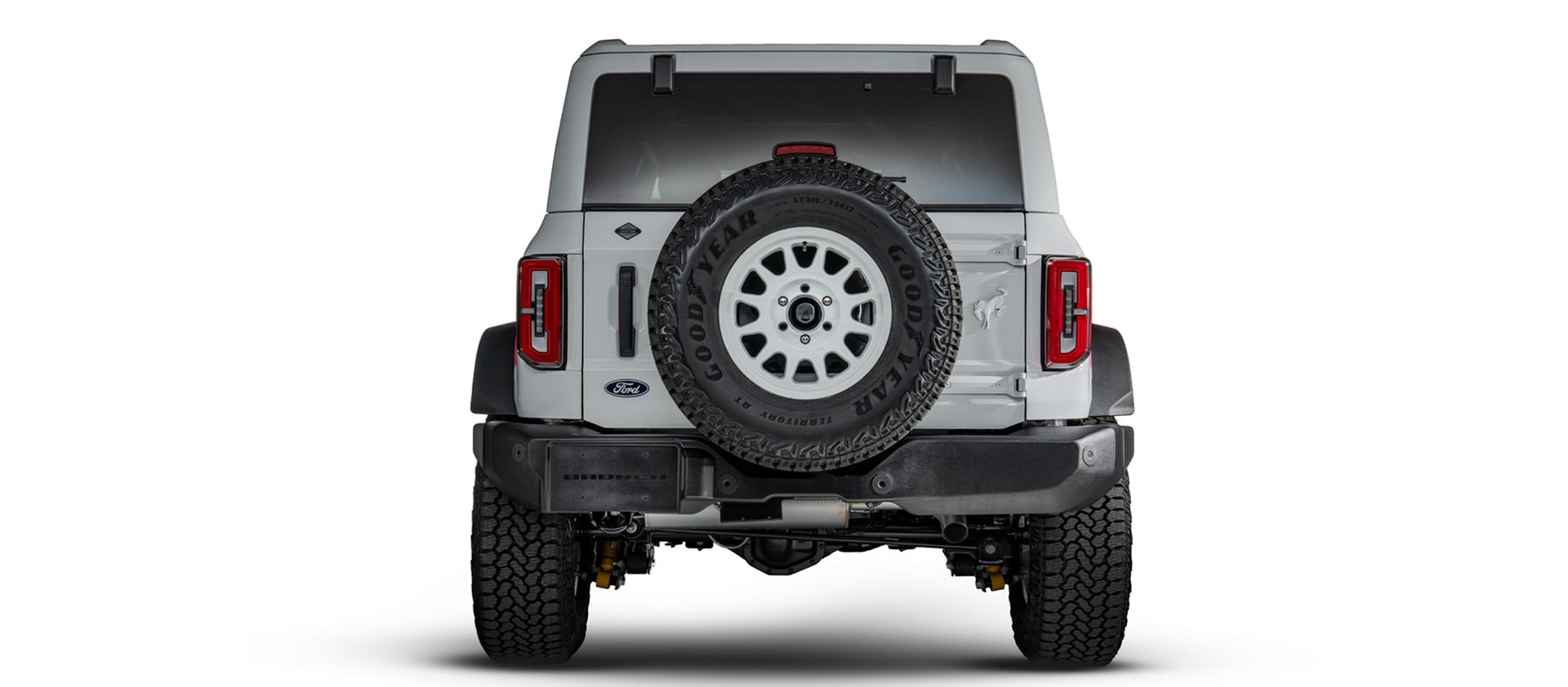 Rear view showing the tailgate, spare tire and painted Bronco badge