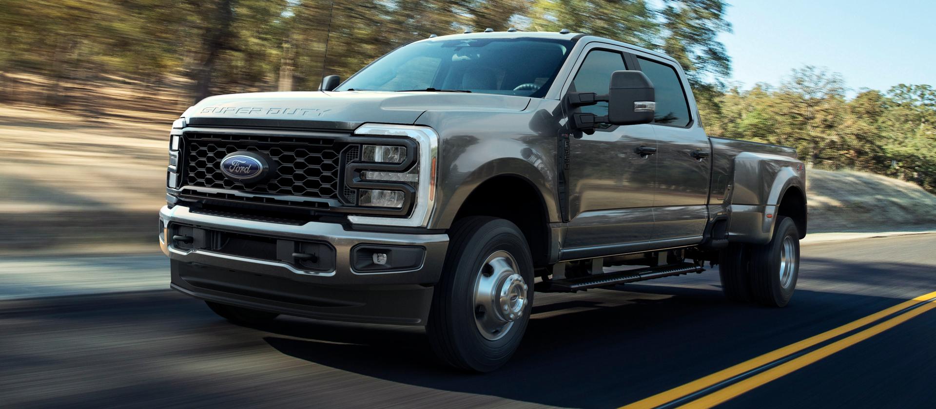 2026 Ford Super Duty® F-250® XL pickup with the STX® Appearance Package in Carbonized Gray driving on a paved road