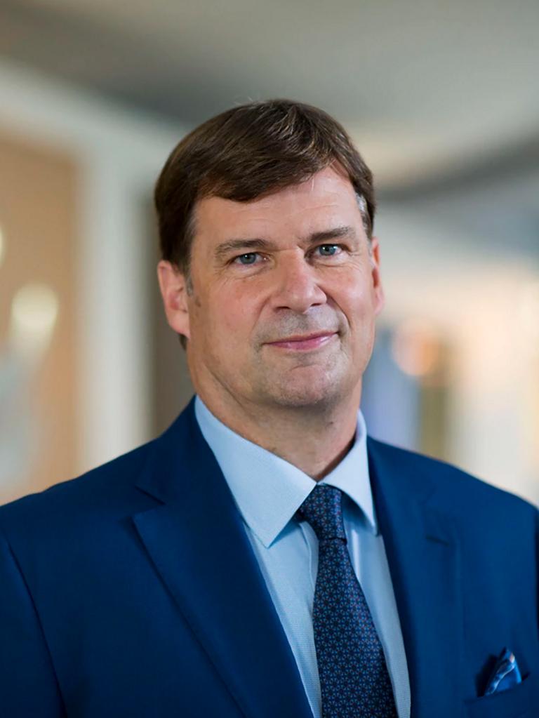 Jim Farley, in an office space, smiles to camera